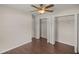 Bedroom with wood floors, double door closet and ceiling fan at 6558 Se 9Th Pl, Ocala, FL 34472