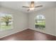 Bright bedroom with wood floors, ceiling fan, and large window at 6558 Se 9Th Pl, Ocala, FL 34472