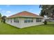 Side view of the house showing multiple windows and a grassy yard at 6558 Se 9Th Pl, Ocala, FL 34472