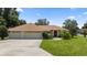 Single-story home with two-car garage and well-manicured lawn at 6558 Se 9Th Pl, Ocala, FL 34472