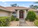 Inviting front entrance with a burgundy door and landscaped walkway at 6558 Se 9Th Pl, Ocala, FL 34472