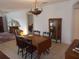 Bright dining room with wooden table and chairs, antique cabinet, and area rug at 7106 Sw 115Th Loop, Ocala, FL 34476