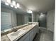 Bathroom features double sink vanity, stylish lighting, and a glass-enclosed shower at 77 Olive Dr, Ocala, FL 34472