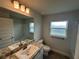 Bright bathroom featuring a single sink vanity, toilet, and shower-tub combo at 77 Olive Dr, Ocala, FL 34472