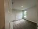 Carpeted bedroom with a large window for natural light at 77 Olive Dr, Ocala, FL 34472