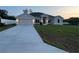 Charming single-story home featuring a well-manicured lawn and attached two-car garage at 77 Olive Dr, Ocala, FL 34472