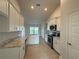 Modern kitchen with white cabinets, granite counters, and stainless steel appliances at 77 Olive Dr, Ocala, FL 34472