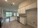 Well-lit kitchen featuring white cabinetry, stainless steel appliances, and tile flooring at 77 Olive Dr, Ocala, FL 34472