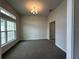 Bright living room with large windows, neutral walls, and plush carpet flooring at 77 Olive Dr, Ocala, FL 34472