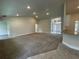 Large open-concept living room with neutral tones, recessed lighting, and carpet flooring at 77 Olive Dr, Ocala, FL 34472