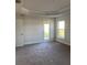 Main bedroom with sliding glass door access to patio at 77 Olive Dr, Ocala, FL 34472