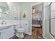 Bathroom with pedestal sink, toilet, and bunk bed view at 7727 Sw 102Nd Loop, Ocala, FL 34476