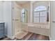 Main bathroom with a walk-in shower, soaking tub, and updated vanity at 7727 Sw 102Nd Loop, Ocala, FL 34476