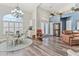 Bright dining room with a glass-top table, white chairs, and a chandelier at 7727 Sw 102Nd Loop, Ocala, FL 34476