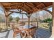 Covered deck pergola with seating for outdoor dining at 7727 Sw 102Nd Loop, Ocala, FL 34476