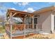 Covered patio with wooden pergola, deck, and outdoor seating at 7727 Sw 102Nd Loop, Ocala, FL 34476