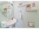 Charming powder room with pedestal sink and decorative wall art at 7727 Sw 102Nd Loop, Ocala, FL 34476