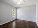 Bedroom with wood floors and a large window at 7795 Sw 181St Cir, Dunnellon, FL 34432