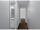 Hallway with dark wood floors and access to bathroom at 7795 Sw 181St Cir, Dunnellon, FL 34432