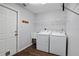 Bright laundry room with washer, dryer, and ample shelving at 7795 Sw 181St Cir, Dunnellon, FL 34432