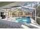 Screened pool and patio area with waterfall feature at 7795 Sw 181St Cir, Dunnellon, FL 34432