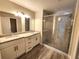 Bathroom featuring double granite vanity top and walk in shower at 7799 Sw 132Nd Pl # 10, Ocala, FL 34473