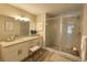 Stylish bathroom with double vanity, granite countertops, and a glass-enclosed shower at 7799 Sw 132Nd Pl # 10, Ocala, FL 34473