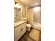 Well-lit bathroom with vanity, marble tile, and shower-tub combination at 7799 Sw 132Nd Pl # 10, Ocala, FL 34473