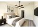 Cozy bedroom with ceiling fan, neutral decor, and hardwood flooring at 7799 Sw 132Nd Pl # 10, Ocala, FL 34473
