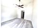Spacious bedroom featuring modern flooring, a ceiling fan, and an ensuite bathroom at 7799 Sw 132Nd Pl # 10, Ocala, FL 34473