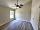 A cozy bedroom showcases a ceiling fan, wood-look flooring, and a window at 7799 Sw 132Nd Pl # 10, Ocala, FL 34473