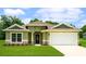 Charming one-story home with green lawn, attached garage, and beautiful stone accents at 7799 Sw 132Nd Pl # 10, Ocala, FL 34473