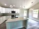 Bright kitchen featuring granite counters, island, and modern light fixtures at 7799 Sw 132Nd Pl # 10, Ocala, FL 34473