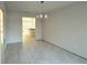 Bright dining room with chandelier and view into kitchen at 8724 Se 157Th Pl, Summerfield, FL 34491