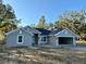 New single-story home with attached two-car garage, freshly poured driveway and landscaping to be completed at 8724 Se 157Th Pl, Summerfield, FL 34491