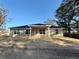 Rear view of new construction home showcasing covered patio and partially landscaped yard at 8724 Se 157Th Pl, Summerfield, FL 34491