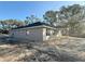 Side view of new construction home showcasing covered patio and partially landscaped yard at 8724 Se 157Th Pl, Summerfield, FL 34491