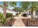 Landscaped backyard patio with pavers, a walkway, and a metal fence at 9176 Sw 93Rd Cir, Ocala, FL 34481