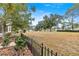 Open backyard view of a lush green golf course beyond the fence at 9176 Sw 93Rd Cir, Ocala, FL 34481