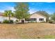 Large backyard with sparse grass and a view of the home's back exterior at 9176 Sw 93Rd Cir, Ocala, FL 34481