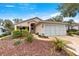 Single-story house with landscaped yard, driveway, and two-car garage at 9176 Sw 93Rd Cir, Ocala, FL 34481