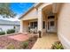 Covered front porch features a sitting area and a view of the garden at 9176 Sw 93Rd Cir, Ocala, FL 34481