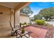 Covered porch with seating area and access to the landscaped yard at 9176 Sw 93Rd Cir, Ocala, FL 34481