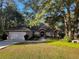 Single-Gathering home with a two-car garage and mature landscaping at 9221 Sw 193Rd Cir, Dunnellon, FL 34432