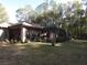 House back view with screened enclosure and spacious yard at 9221 Sw 193Rd Cir, Dunnellon, FL 34432