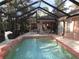 Inviting screened pool area with a tiled deck and fountain at 9221 Sw 193Rd Cir, Dunnellon, FL 34432