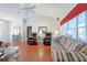 Bright living room with hardwood floors, comfortable seating, and ceiling fan at 9688 Sw 45Th Ave, Ocala, FL 34476