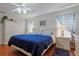 Main bedroom with blue comforter and ceiling fan at 9688 Sw 45Th Ave, Ocala, FL 34476