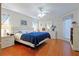 Large main bedroom with a blue comforter and wood floors at 9688 Sw 45Th Ave, Ocala, FL 34476