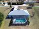 Large screened-in pool with solar panels on the roof at 9688 Sw 45Th Ave, Ocala, FL 34476